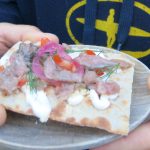 Fermented herring on a bit of bread, with red onion and dill